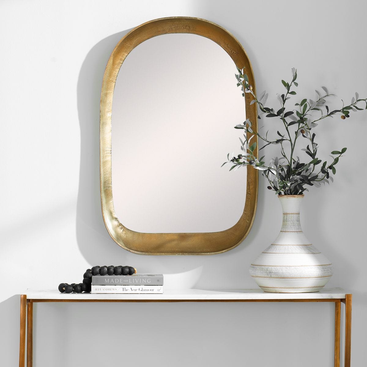 Arched Brass Mirror above Console.