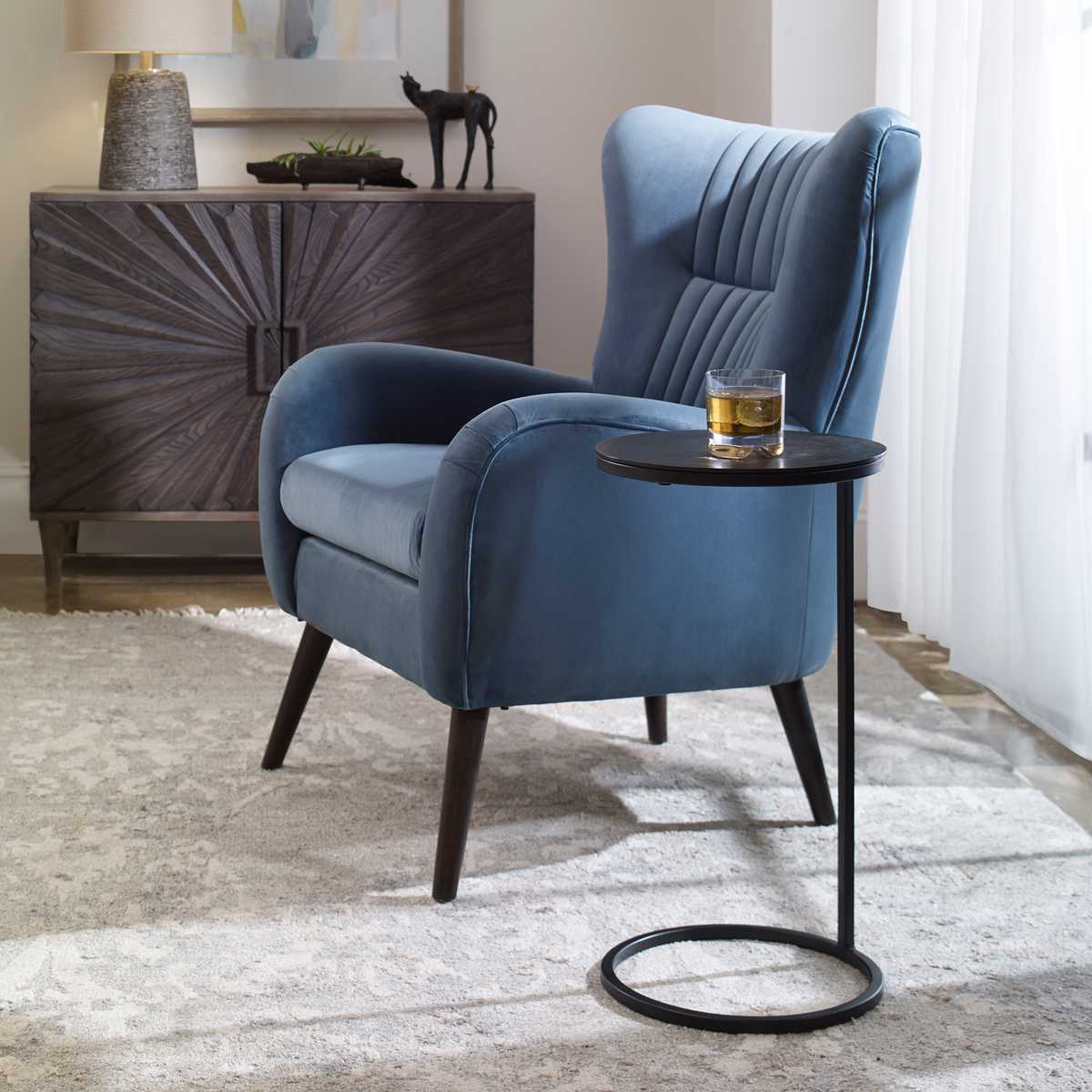 Blue armchair with a side table in a room setting