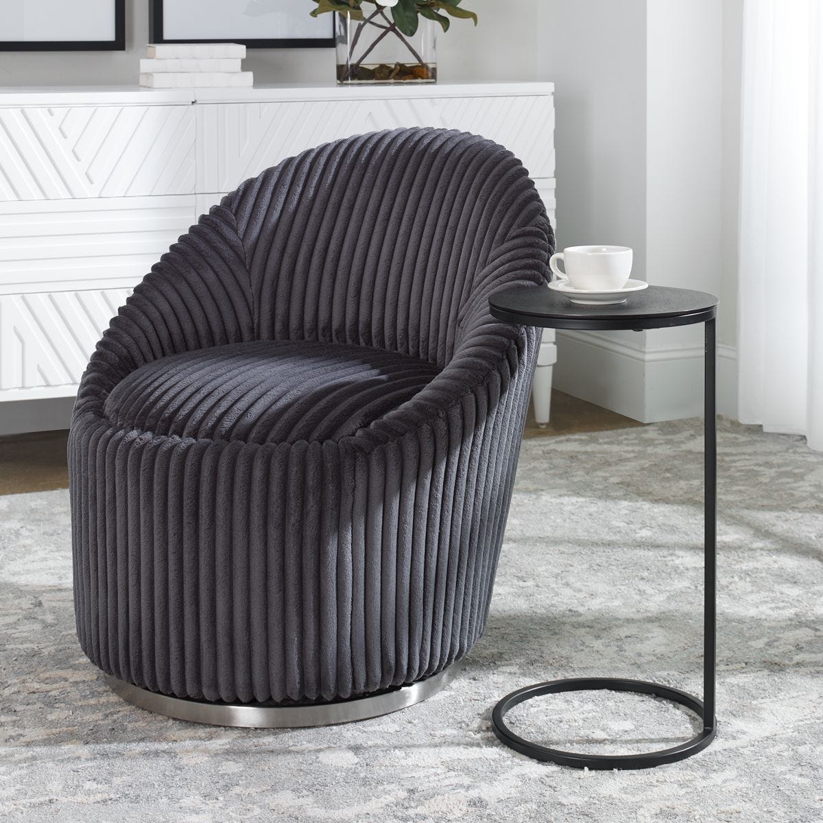 Modern gray chair with a side table in a room setting