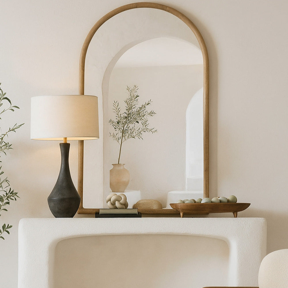 Modern interior with a white console table, lamp, and mirror in a neutral-colored room.