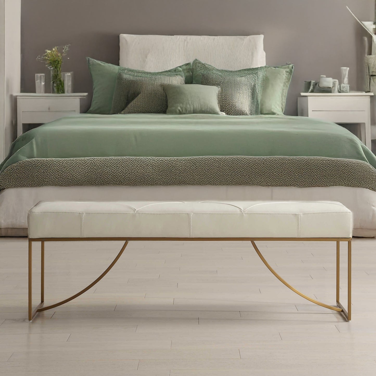 White upholstered bench at end of white bed.