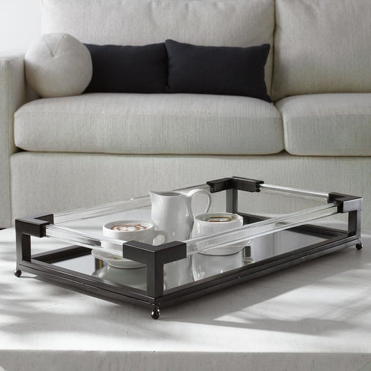 Black metal acrylic tray with mirrored bottom with martinis on a concrete coffee table.