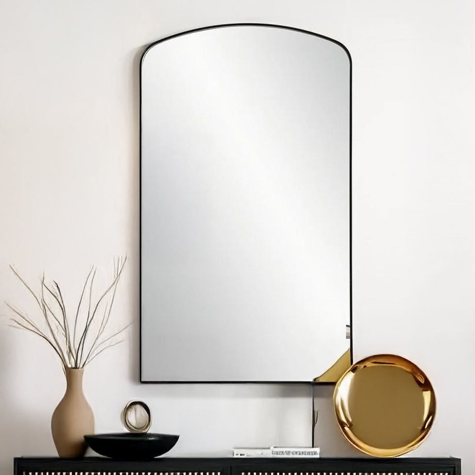 Black arched mirror above console.