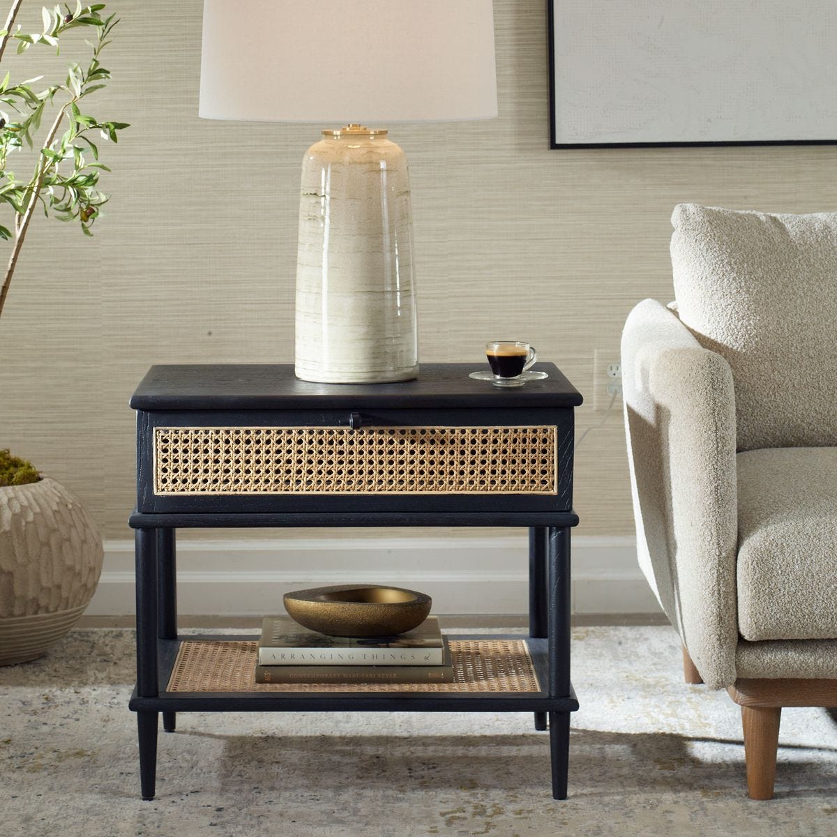 Navy side table with wicker drawer and shelf in a living room setting