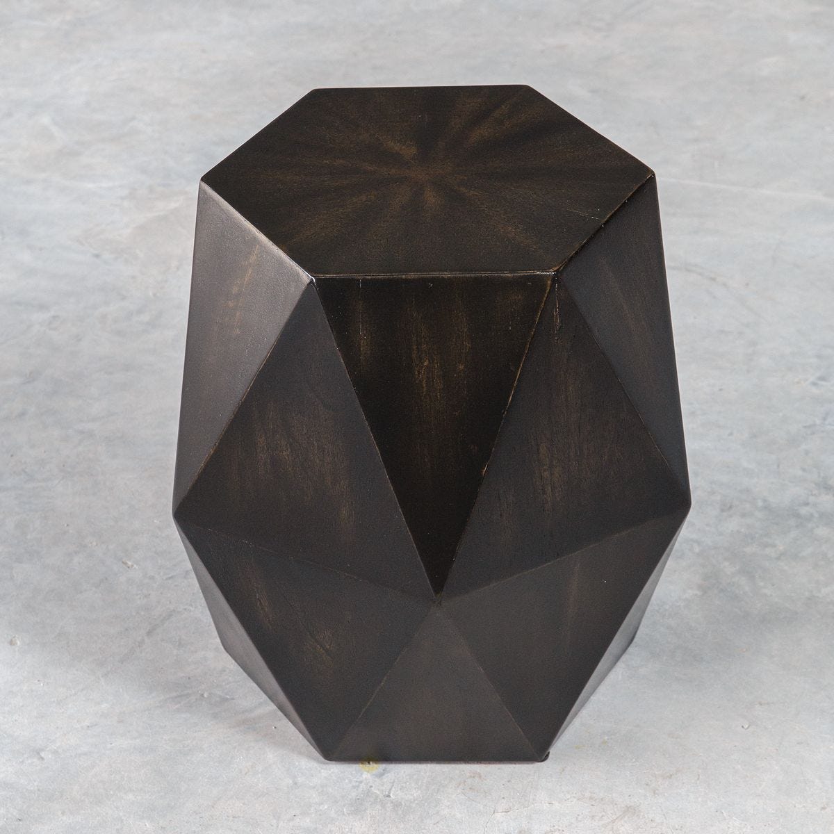 Geometric dark brown side table on a light gray background