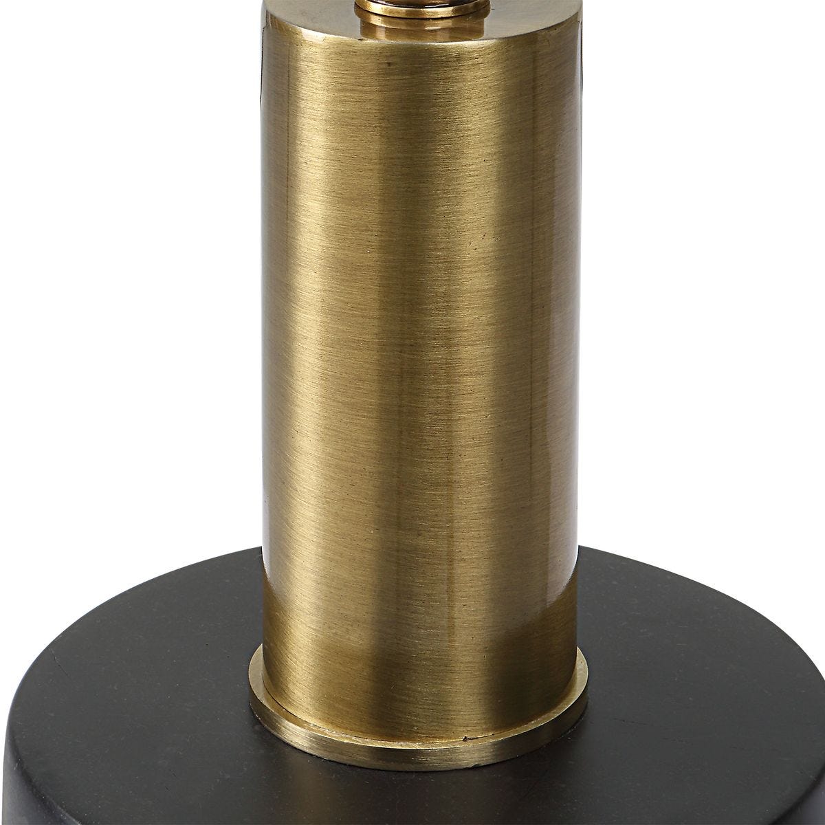 Brass cylindrical object on a black base against a white background
