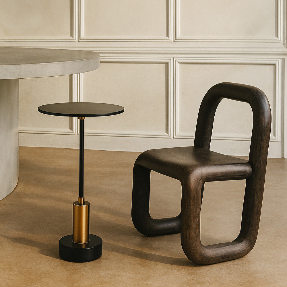Modern brown chair and small round table against a beige wall.