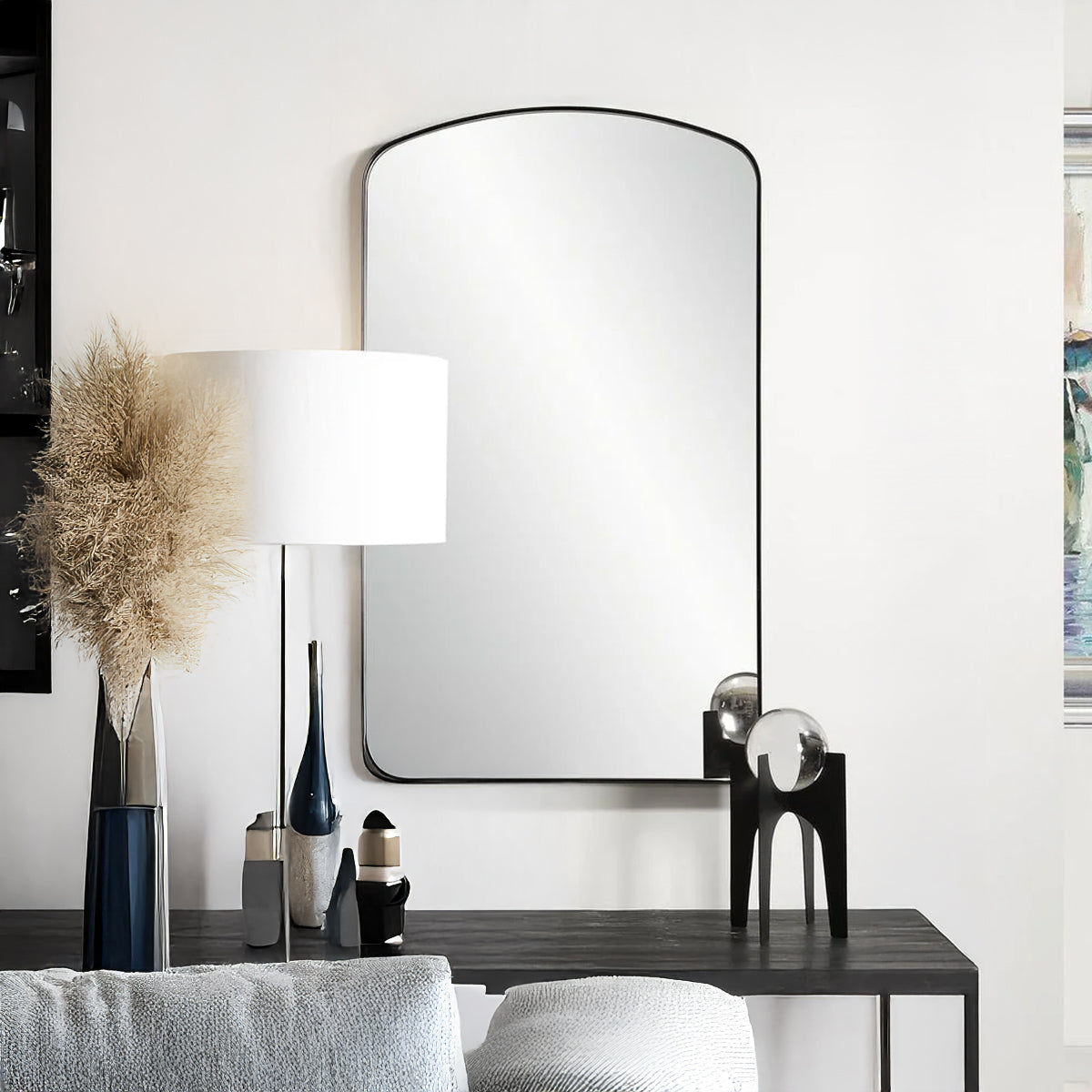 Black metal mirror with arch.