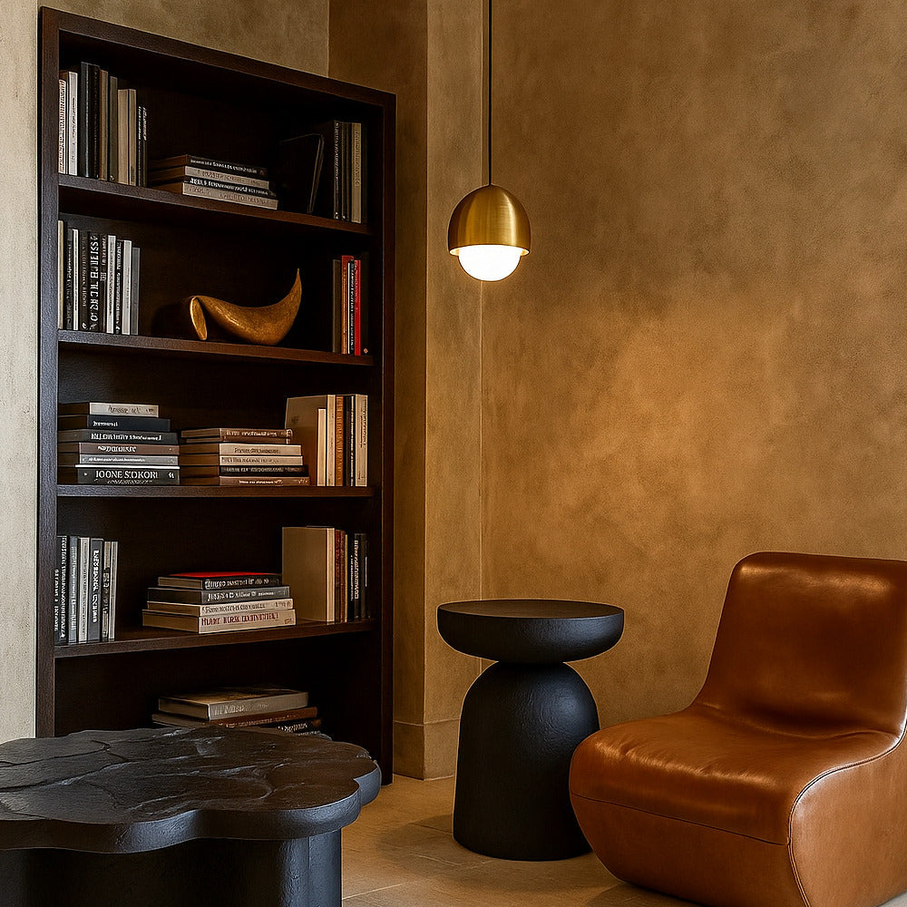 Modern interior with a bookshelf, brown chair, and black side table against a beige wall.