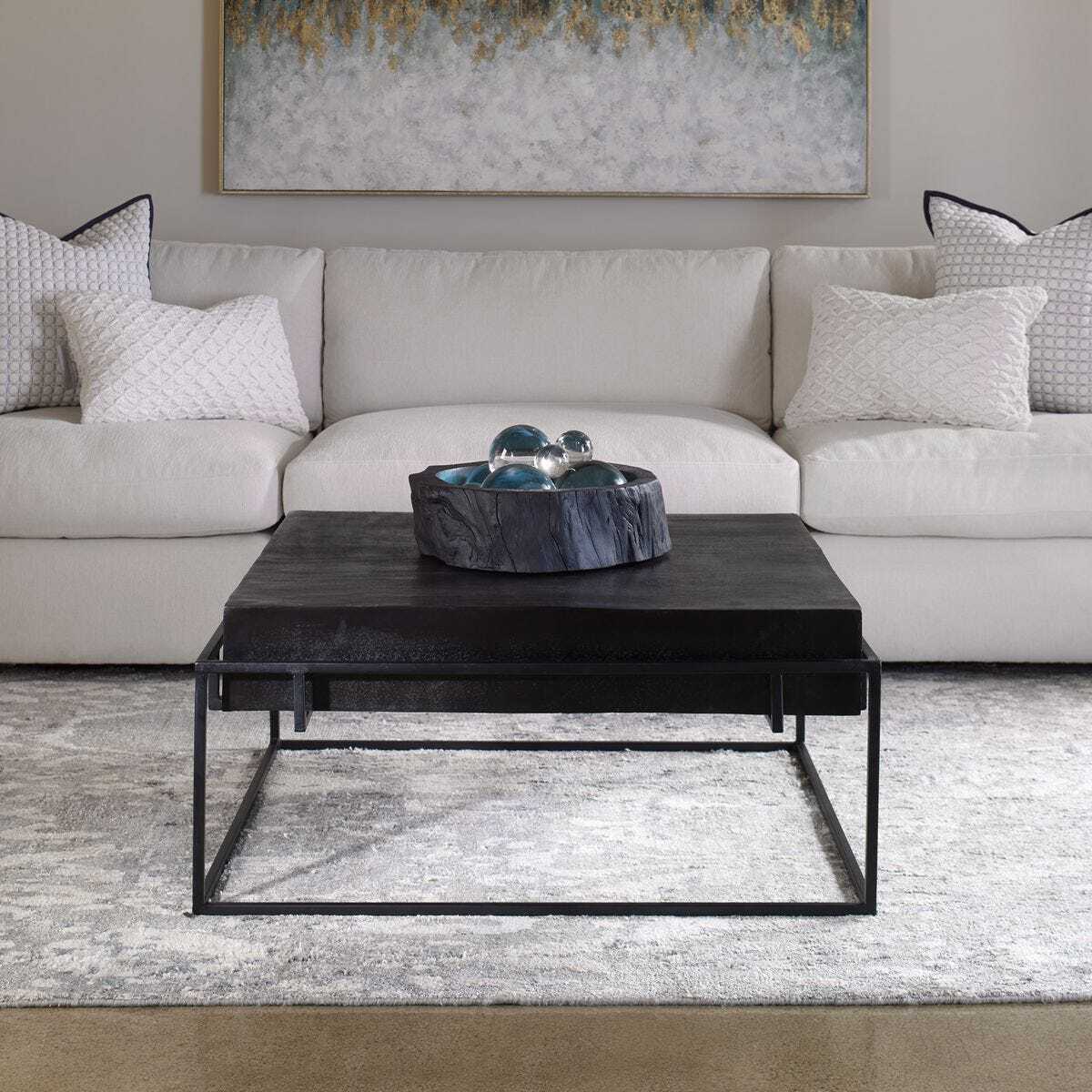 Modern living room with a gray sectional sofa and black coffee table.