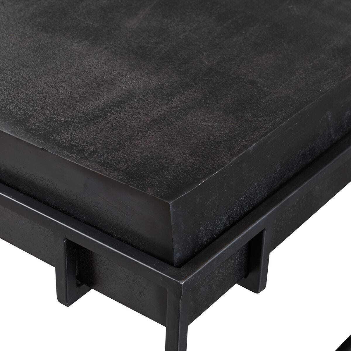 Black metal bench with textured surface on a white background