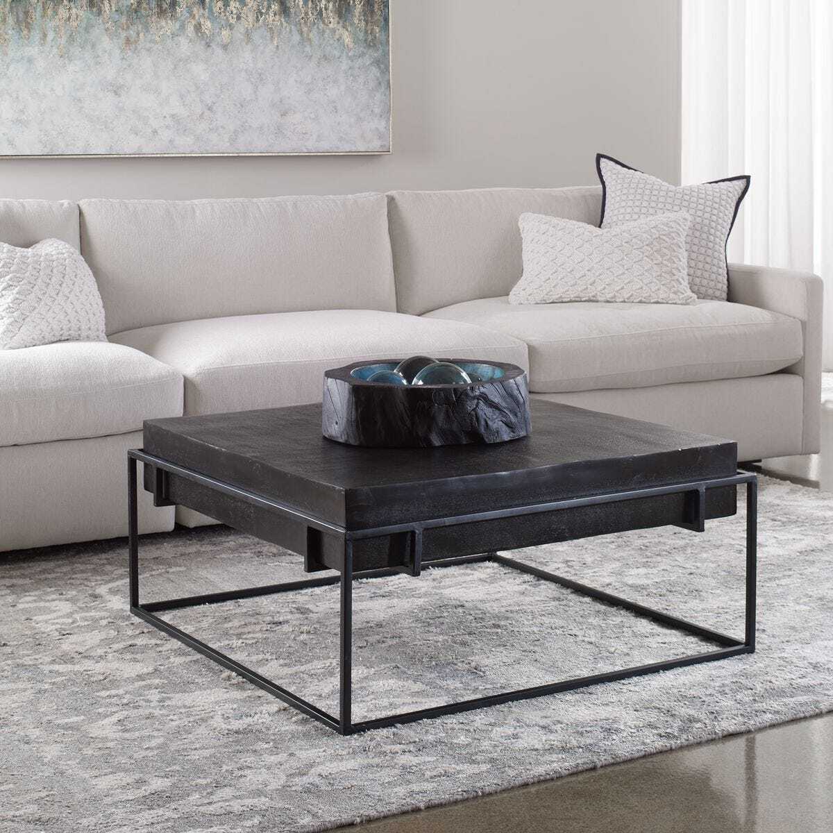 Modern living room with a gray sectional sofa and dark coffee table.
