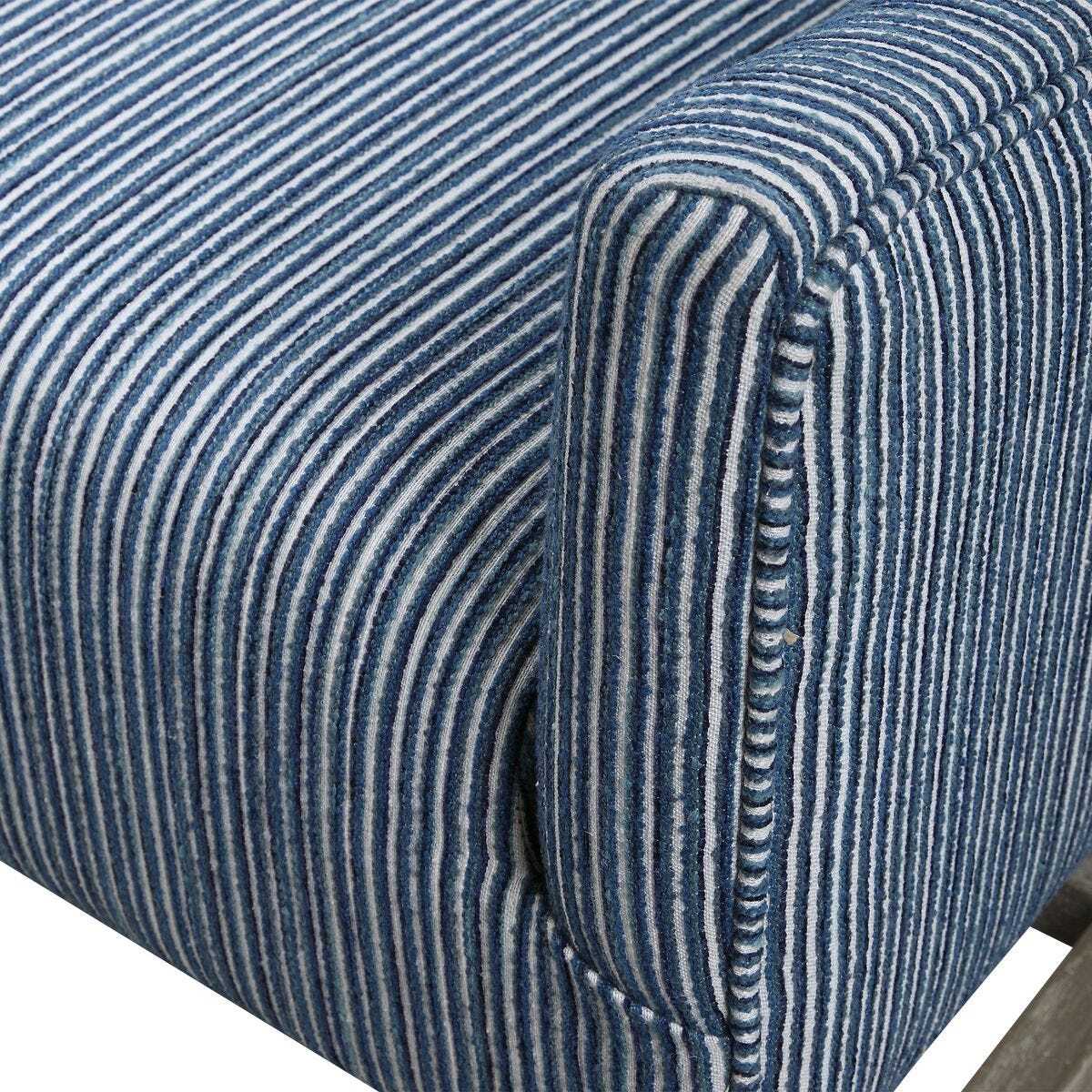 Close-up of a blue striped fabric with a visible seam