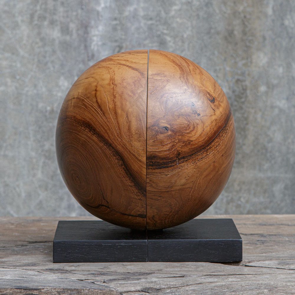 Wooden sphere on a black base with a textured background