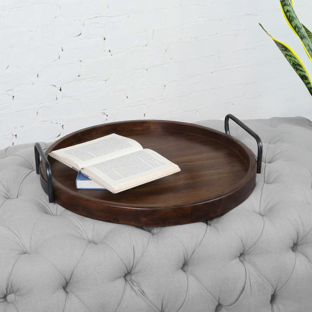 Round 24 inch ottoman tray with book pen and snake plant.
