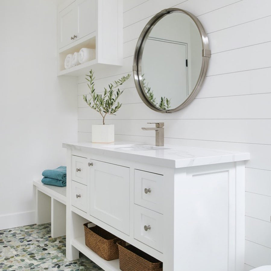 Brushed Nickel Mirror above White Vanity.