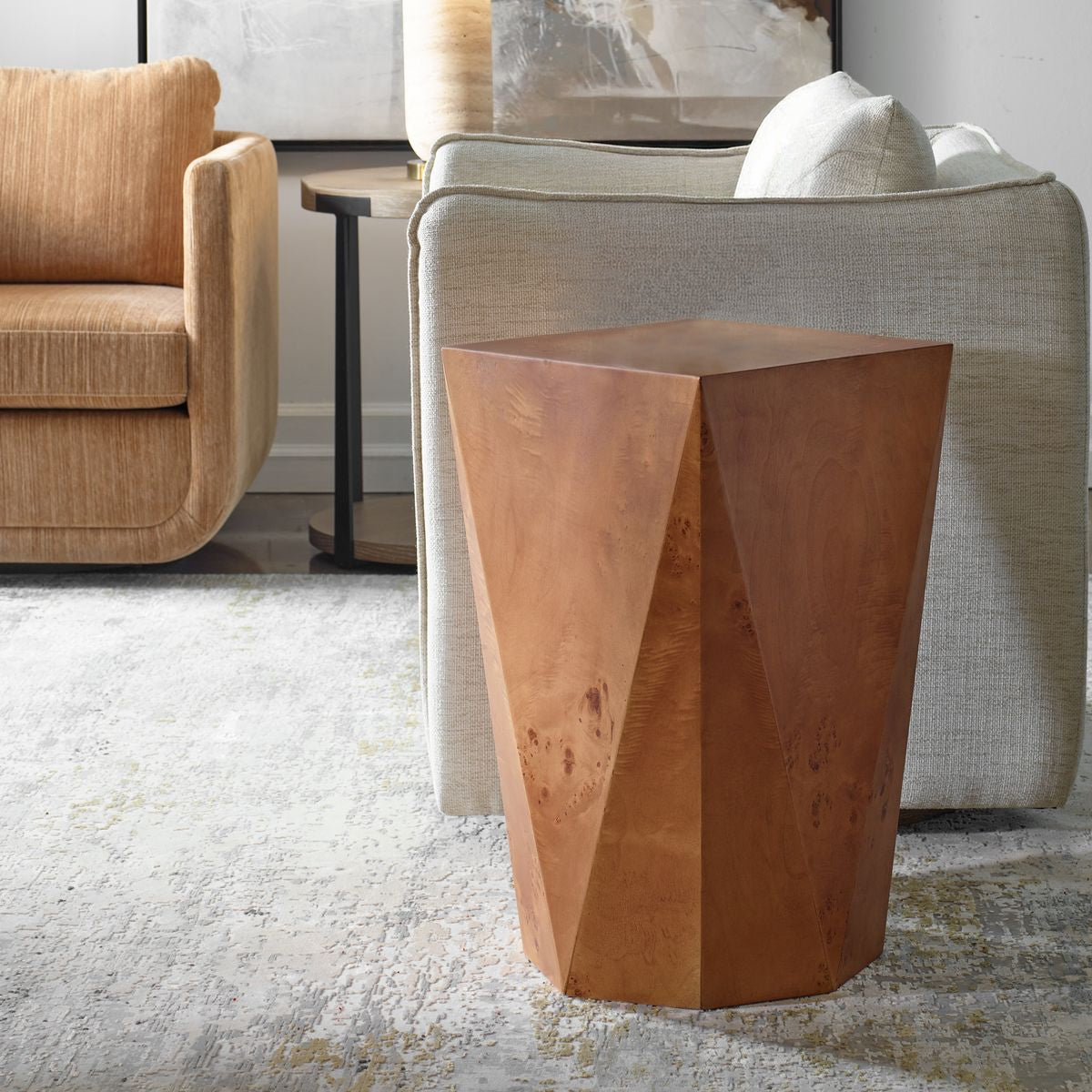 A burl wood side table with a geometric silhouette, placed in a living room setting.