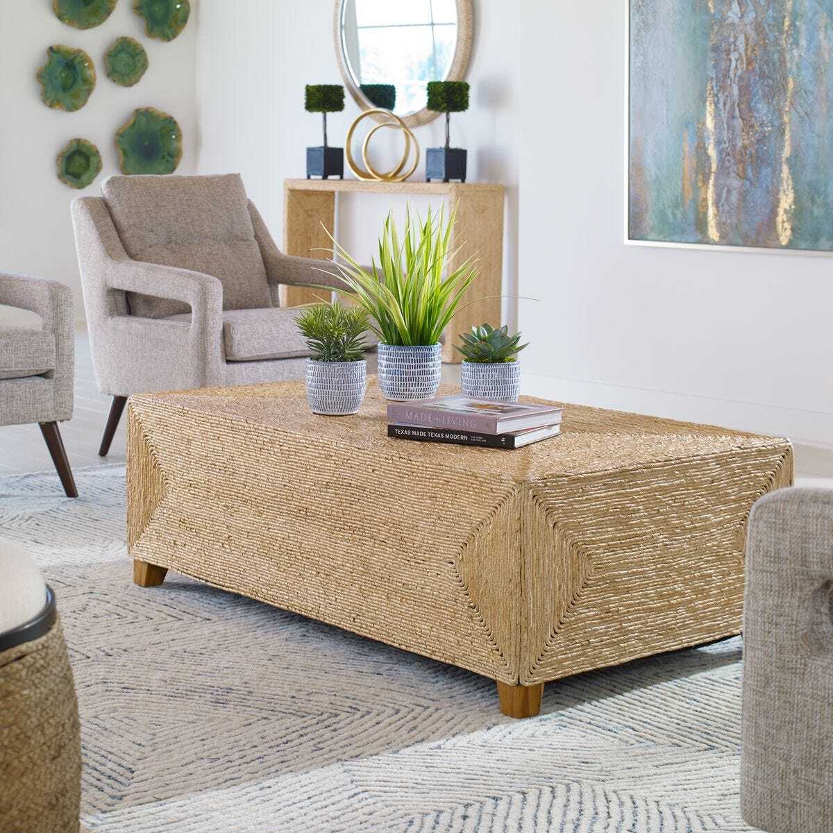 Living room with a textured coffee table, armchairs, and decorative elements.