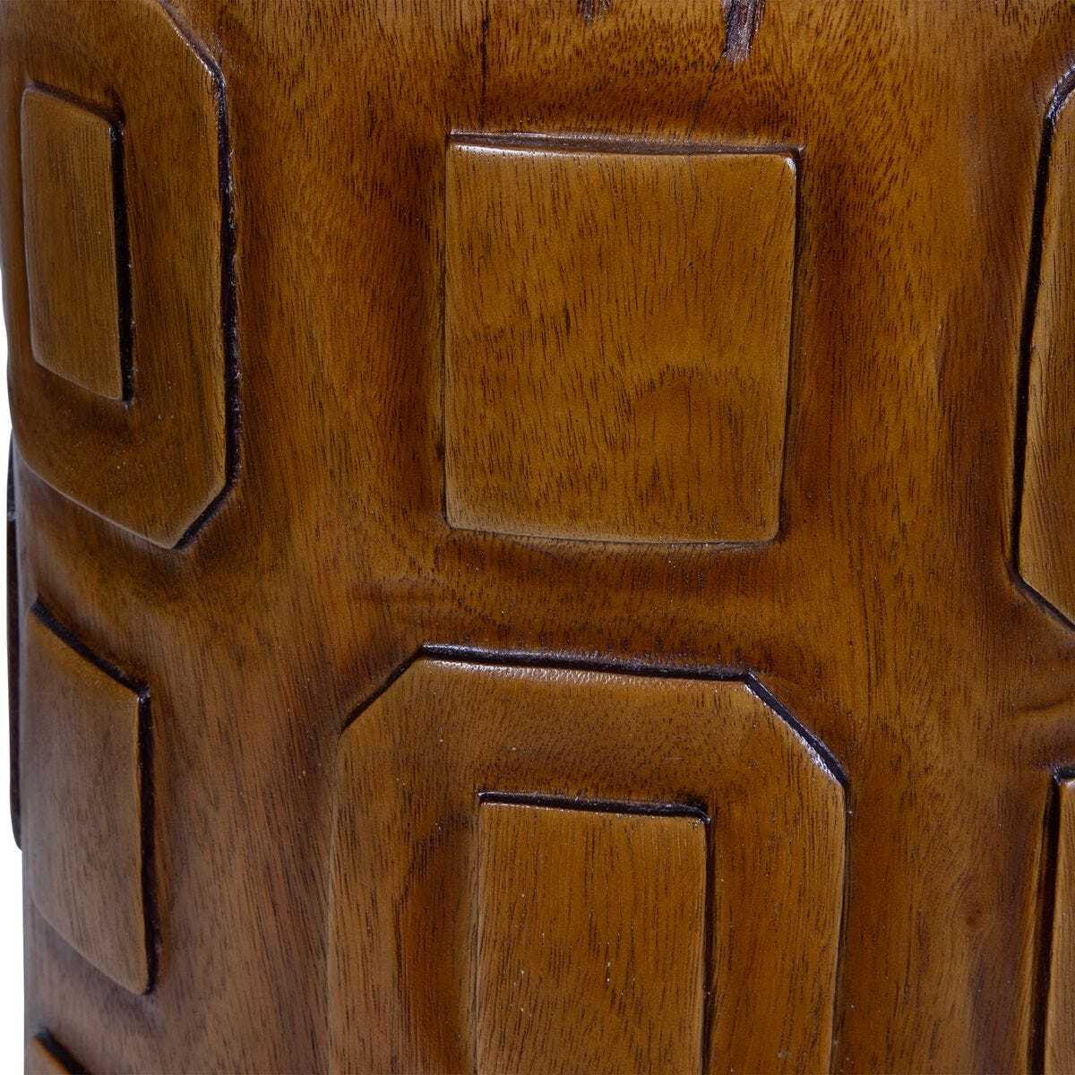 Close-up of a wooden stool with geometric carvings