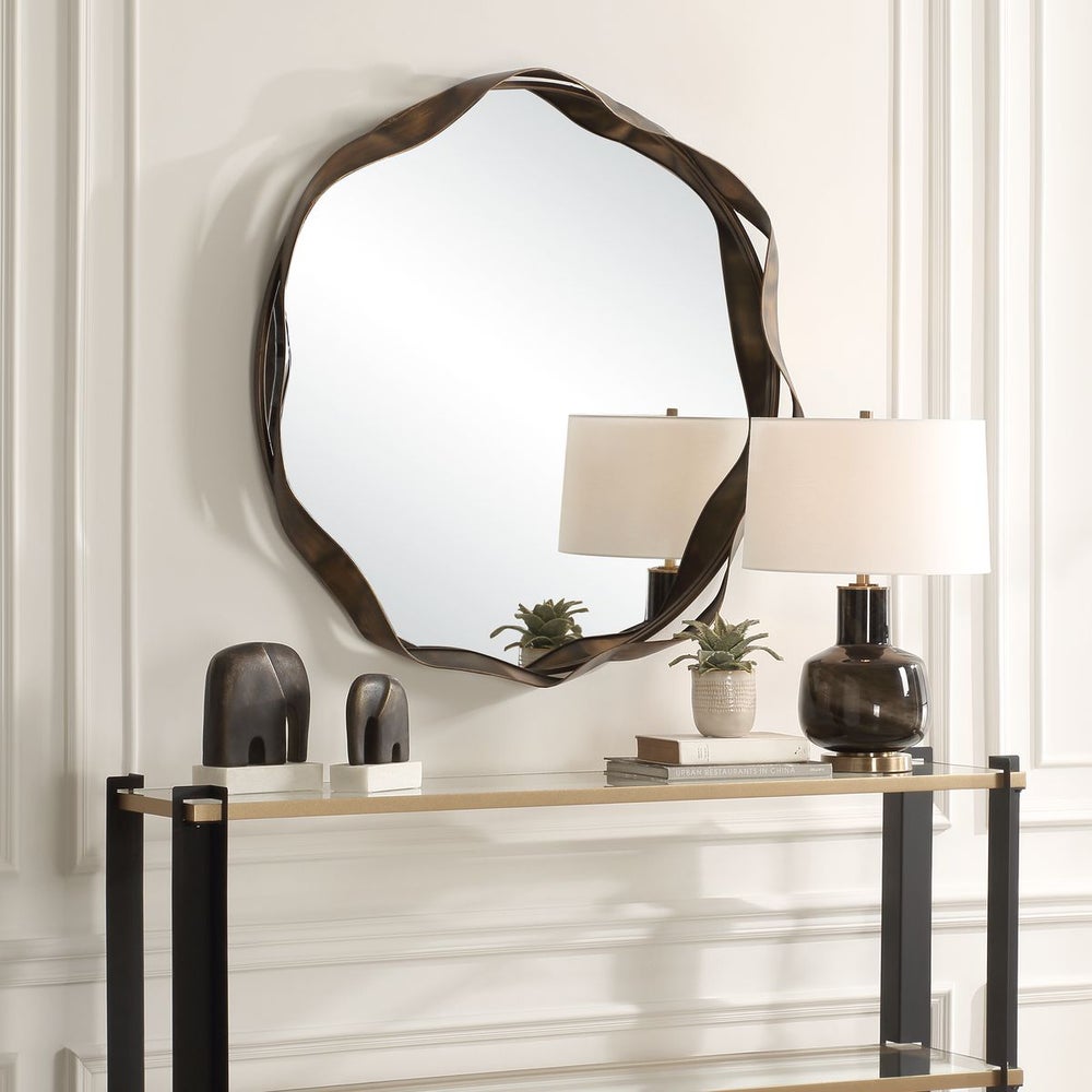 Champange bronze mirror above console.