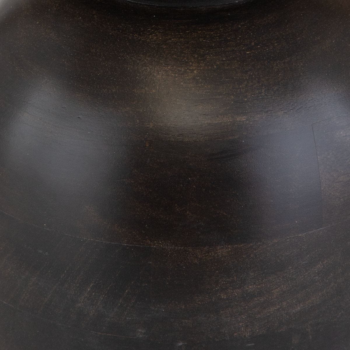 Close-up of a dark brown leather surface with visible texture