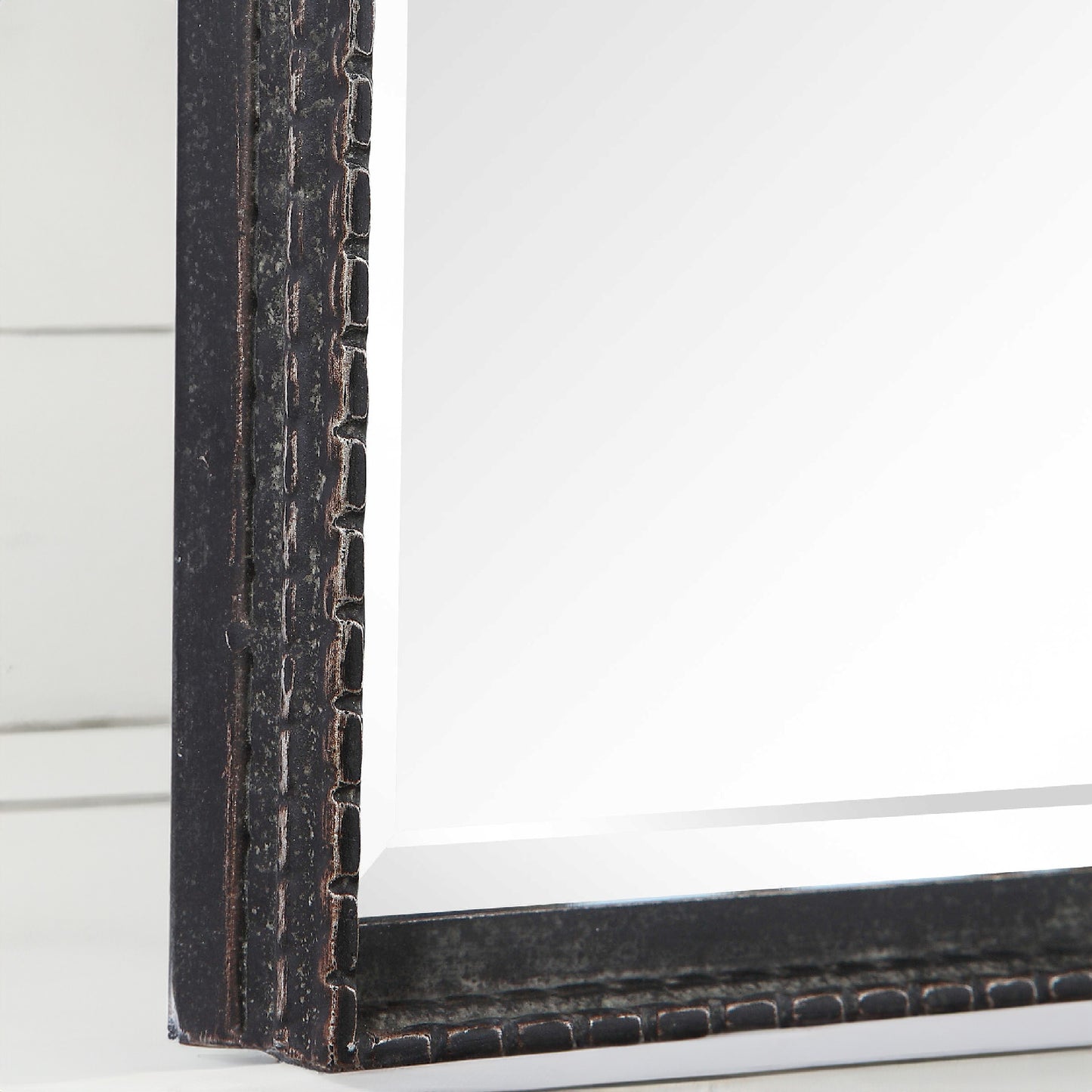 Details of rustic black iron mirror frame.