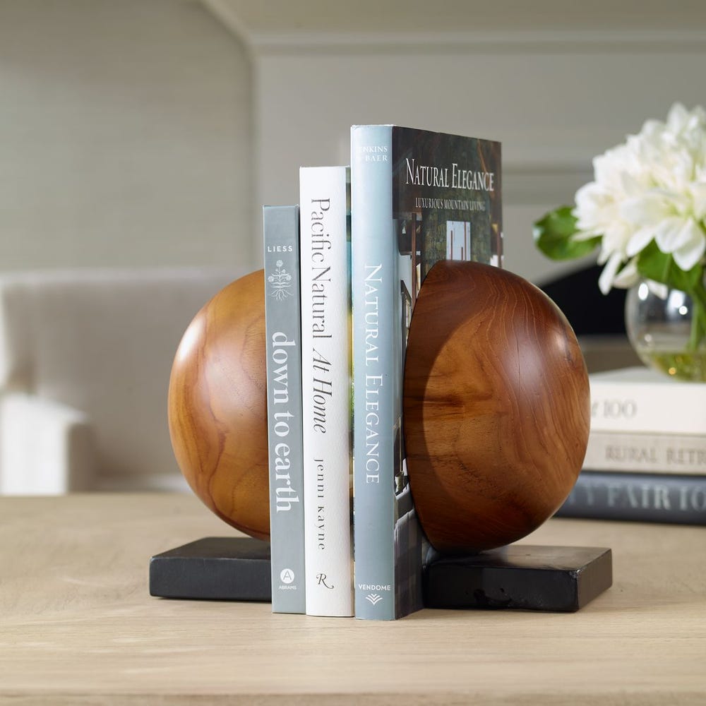 Wooden bookends holding books on a table.