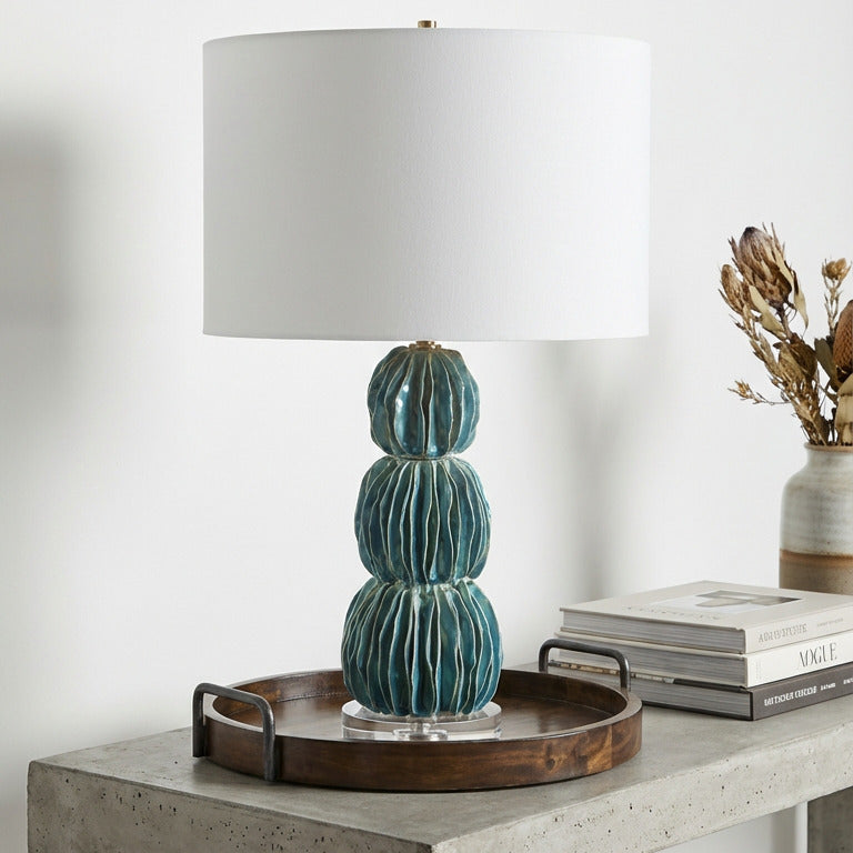 Decorative cactus lamp on a concrete table with a white background