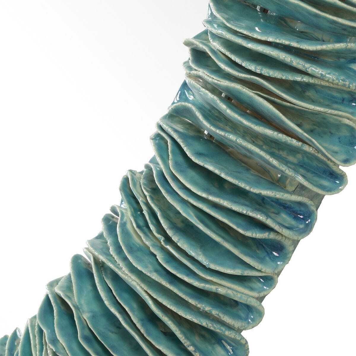 Close-up of a textured blue ceramic vase on a white background