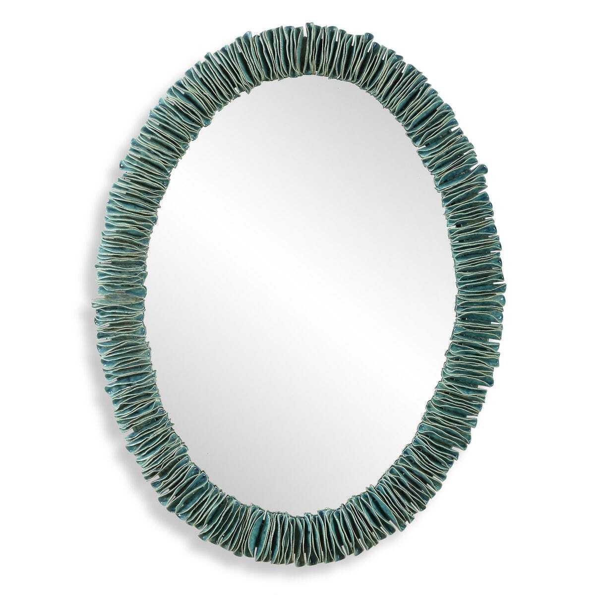 Oval mirror with a textured teal frame on a white background
