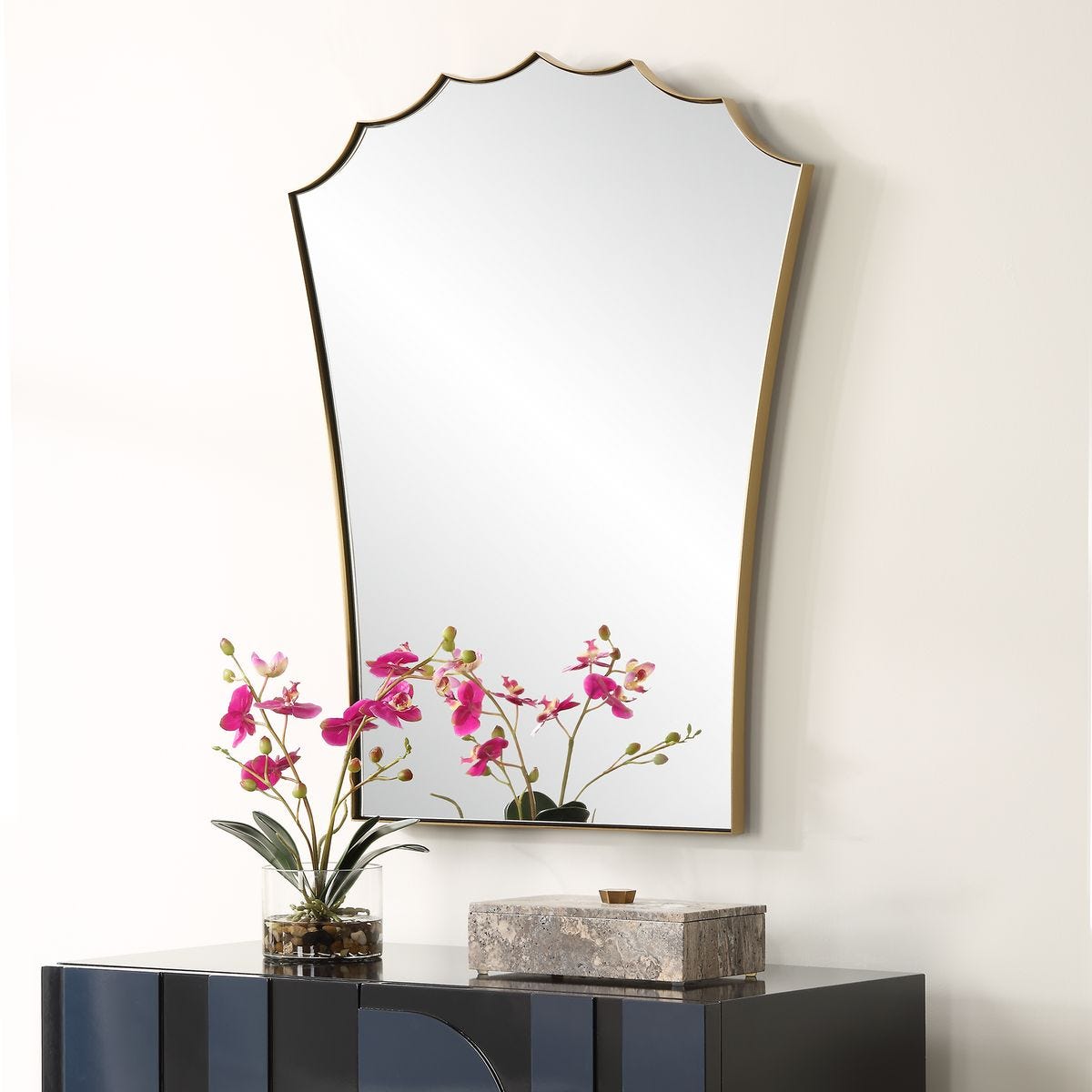 Decorative mirror with a floral arrangement on a reflective surface