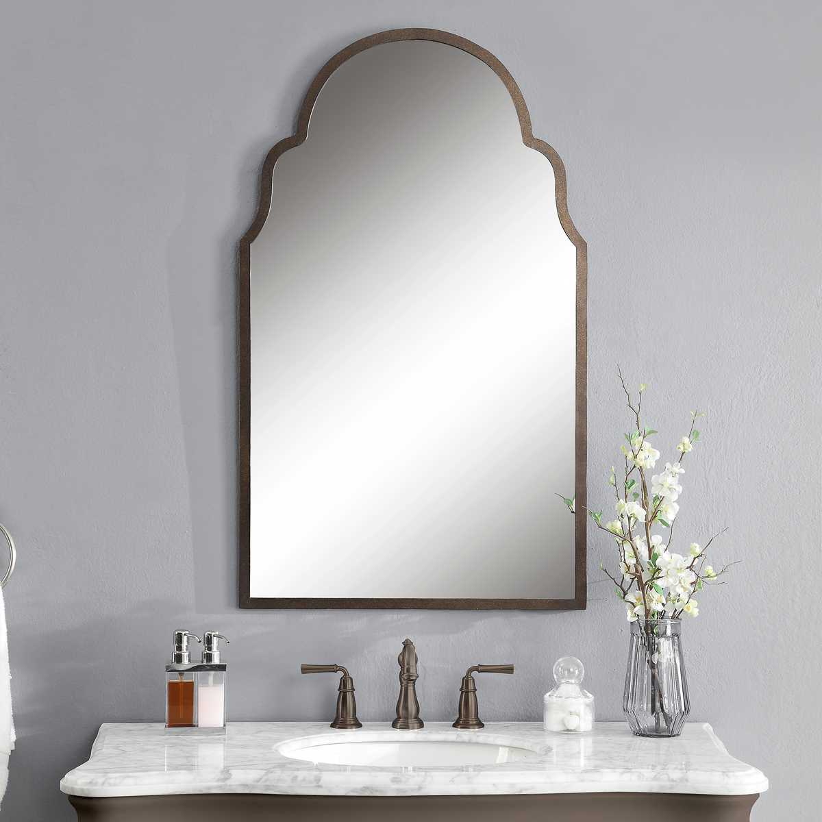 Bathroom vanity with mirror, sink, and decorative elements on a gray wall.