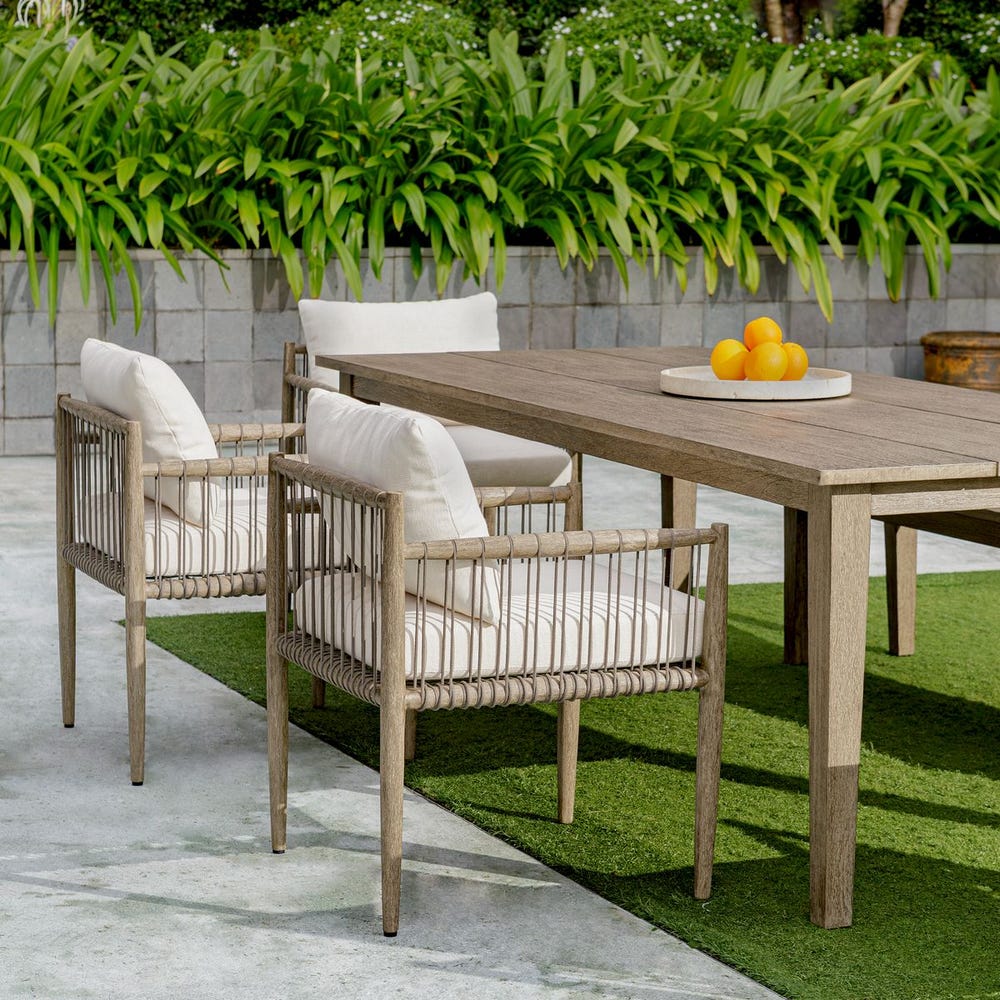 Outdoor furniture set with wooden table and chairs on a patio
