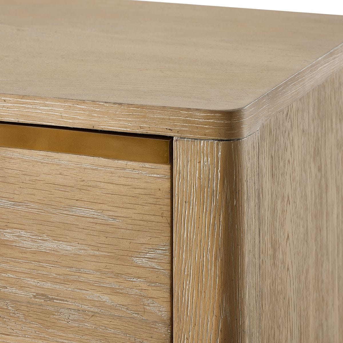 Close-up of a wooden cabinet with a gold accent