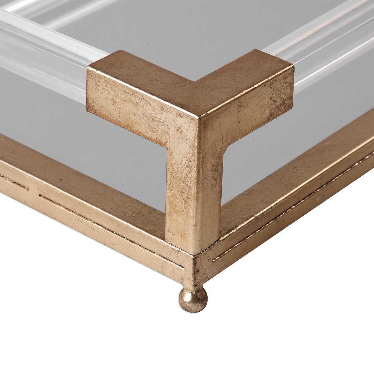 Close-up of a glass tray with a gold metal frame on a white background