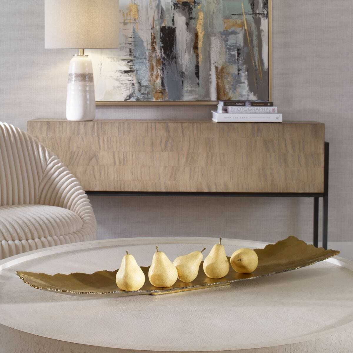 Decorative tray with pears on a coffee table in a stylish living room.