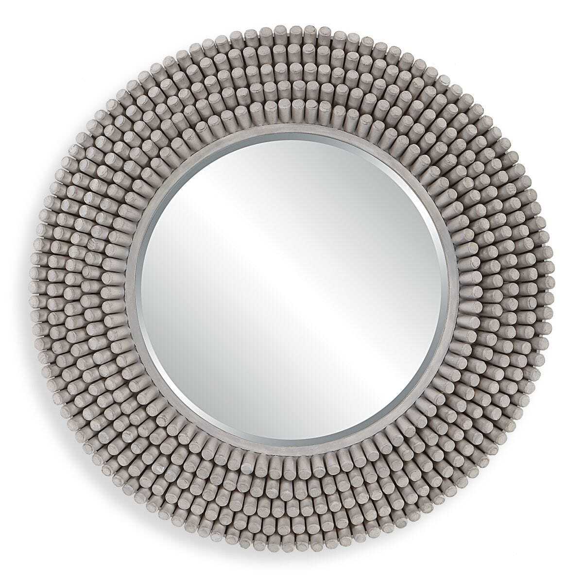 Round mirror with a textured bead-like frame on a white background