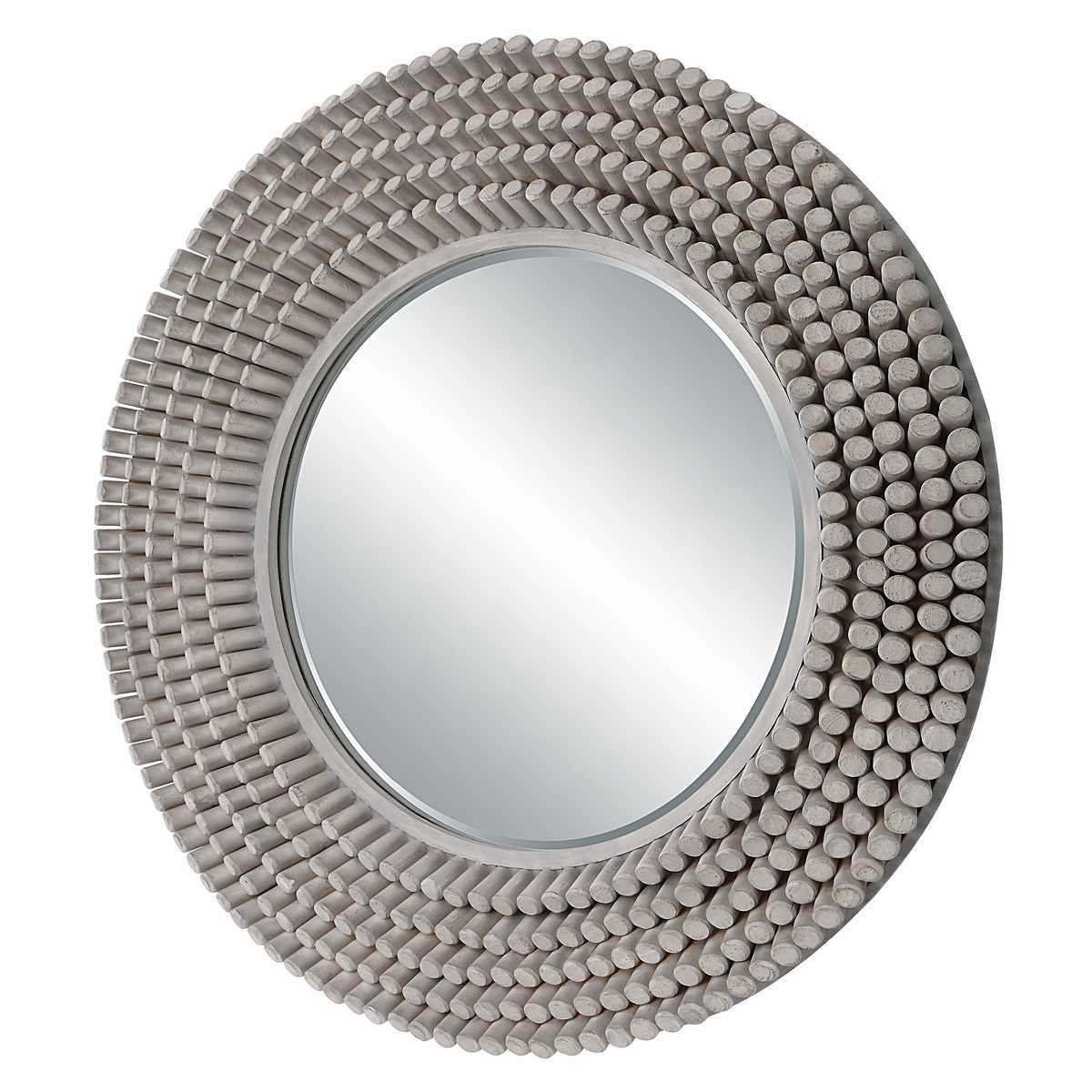 Round mirror with textured beige frame on a white background
