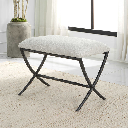 Small bench with gray cushion and distressed metal legs in a transitional living room with contemporary rug in yellow.