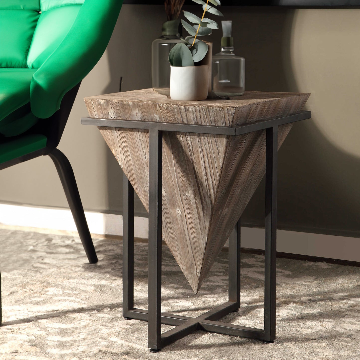 Industrial end table and eucalyptus on top.