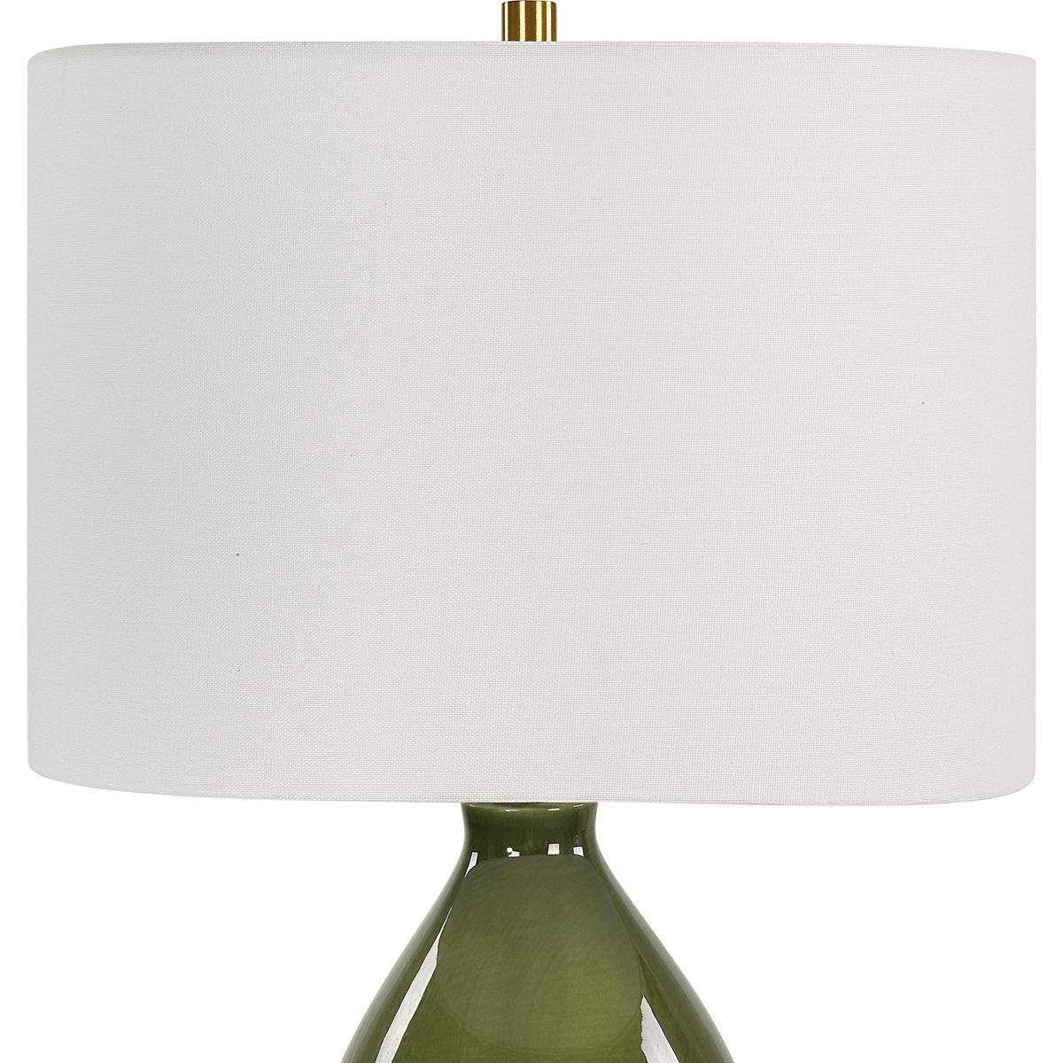 Table lamp with a green base and white shade on a white background