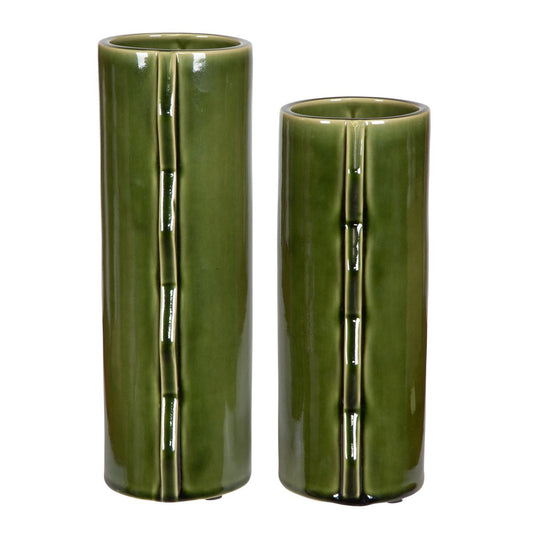 Set of two Green zig-zag contemporary modern ceramic vases, on a table with books behind them.