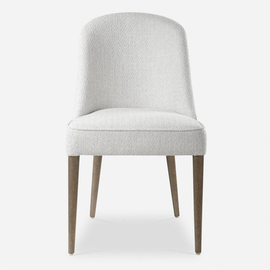 A perfect modern dining chair featuring a casual off-white textured fabric, welted trim, and light walnut solid wood legs.