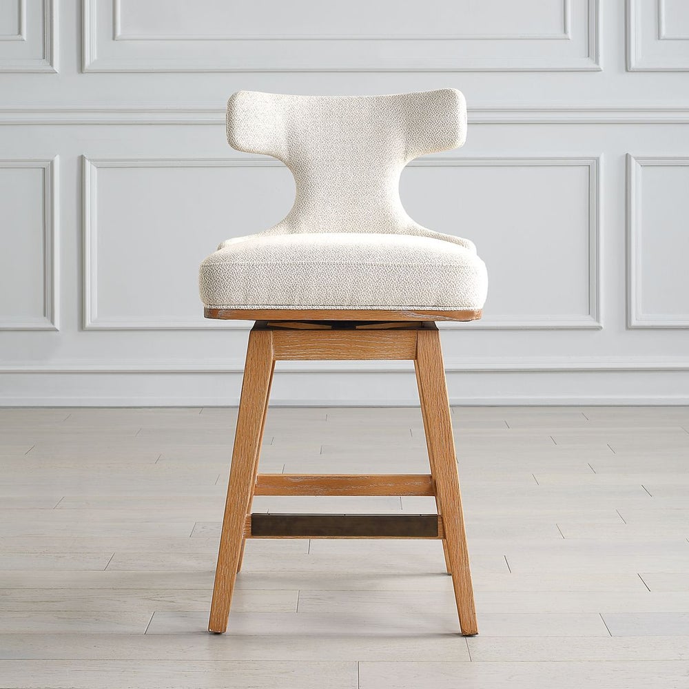 Beautiful white Klismos counter stool that swivels shown in front of kitchen counter.