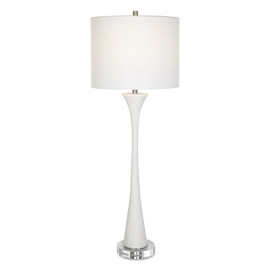White buffet ivory table lamp on console with ocean art on wall showing behind it.