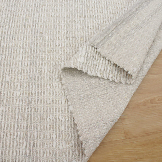 Ivory area rug in living room.