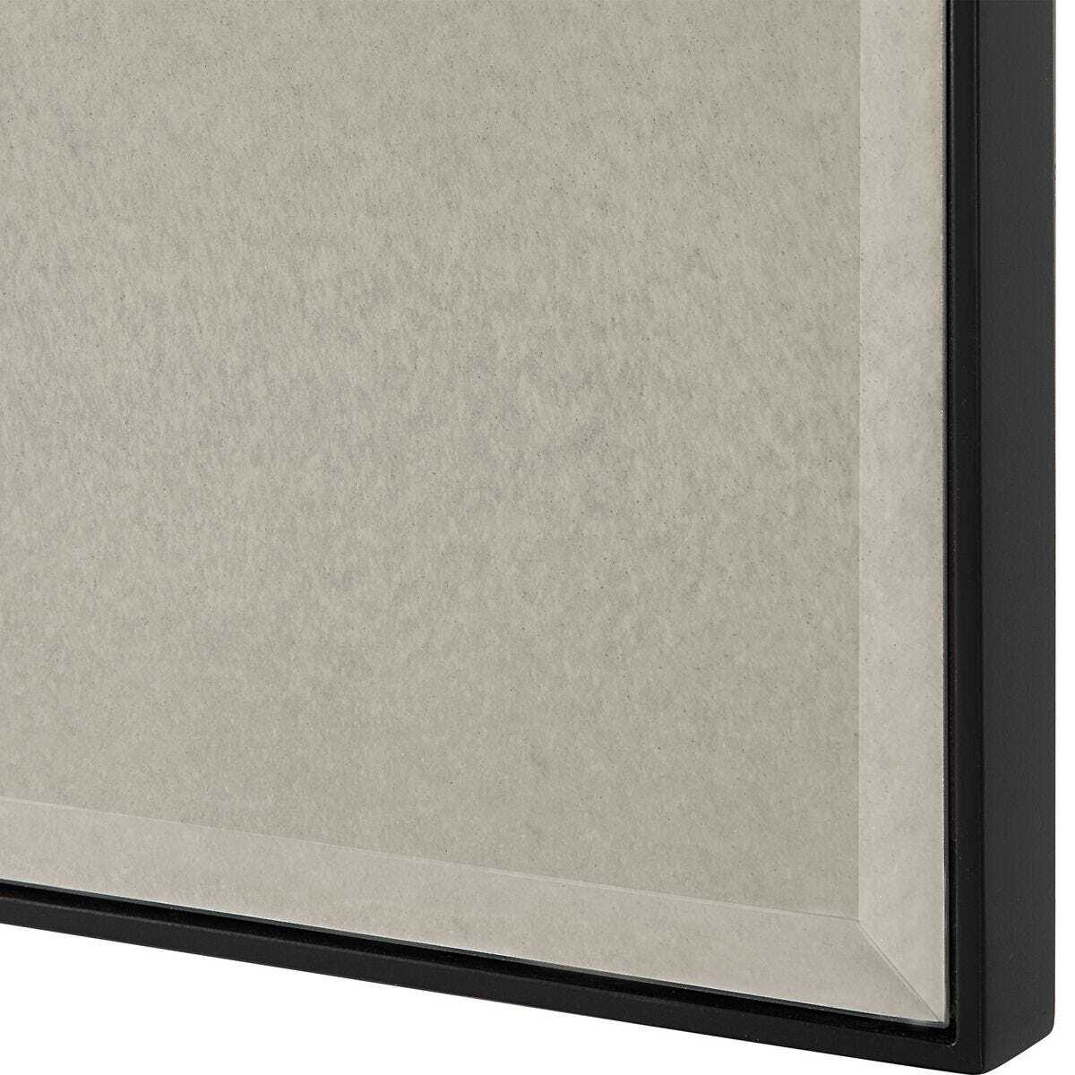 Close-up of a textured wall with a black frame corner.