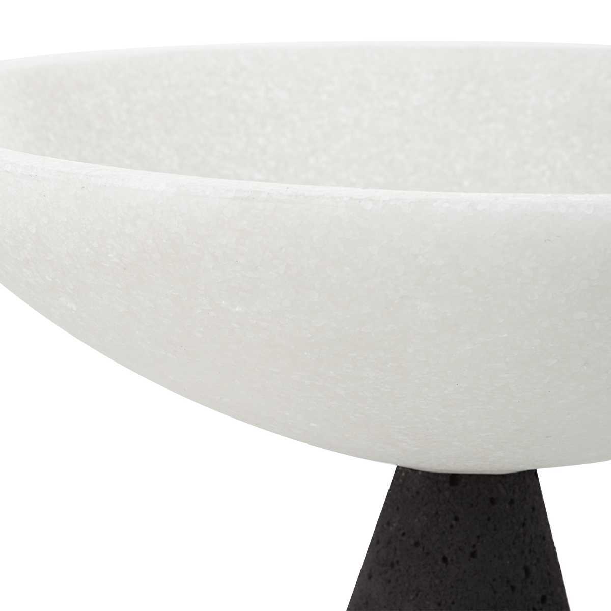 Close-up of a modern table with a white ceramic top and black base.