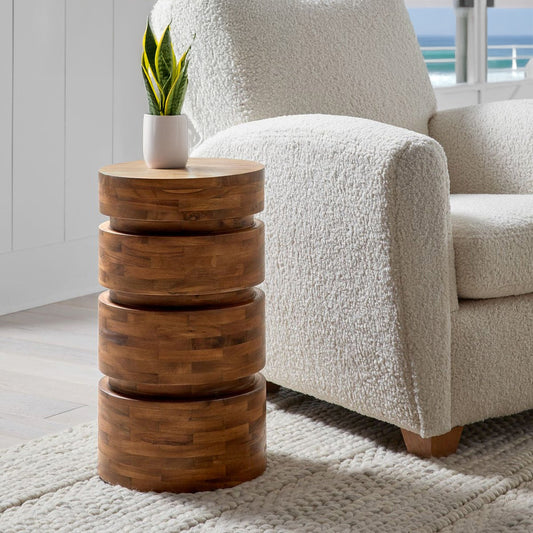 mid-century modern wood accent table at the side of a white sofa in a living room.