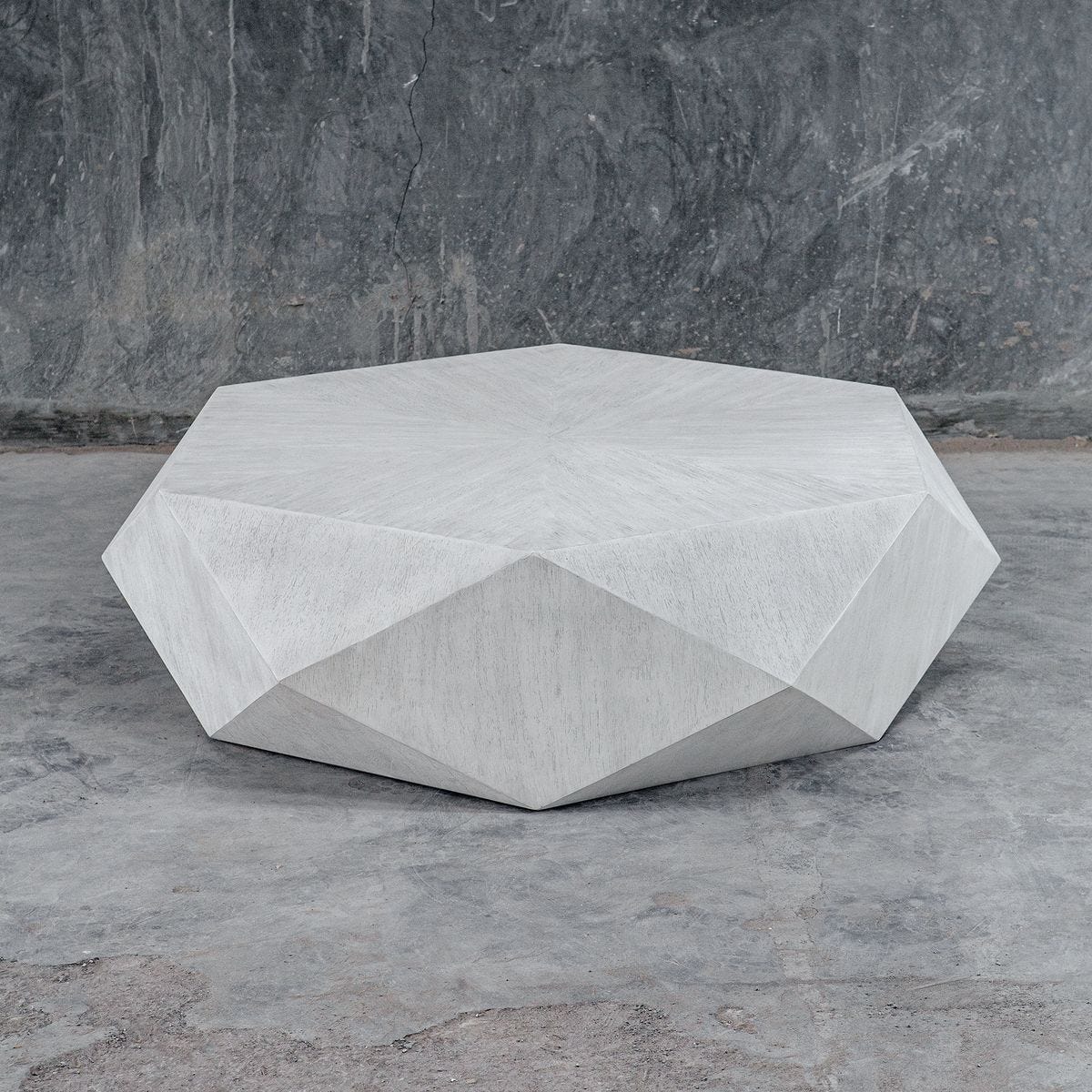 Modern white coffee table on concrete floor.